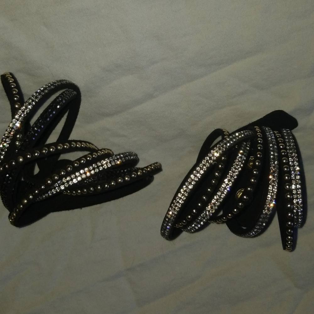 Pair of black, gold and silver wrap bracelets.